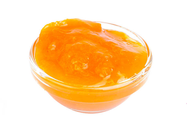 istock Apricots jam in glass isolation on white 477171957