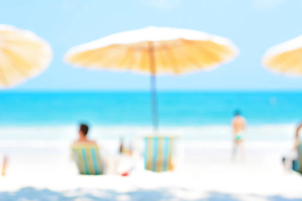 istock Blurred image of people relaxing at the beach 477173184