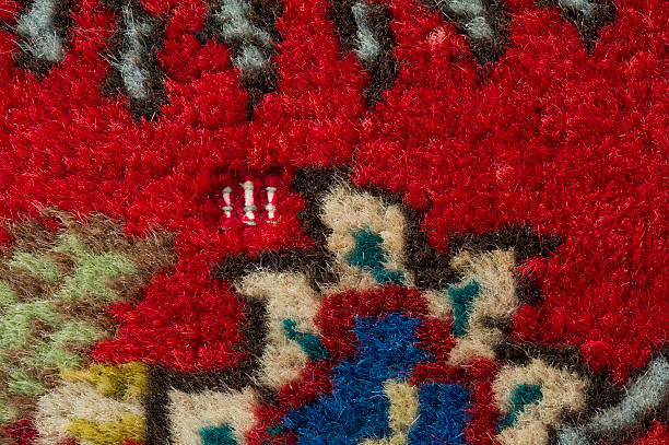istock Antique hand-knotted persian wool rug with moth damage 477173812