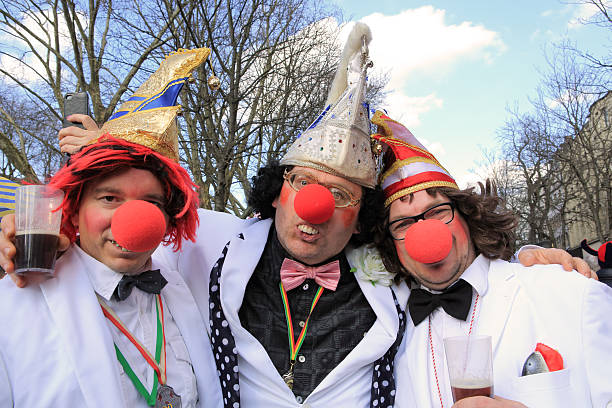 three men with clown noses in Dusseldorf street carnival stock photo