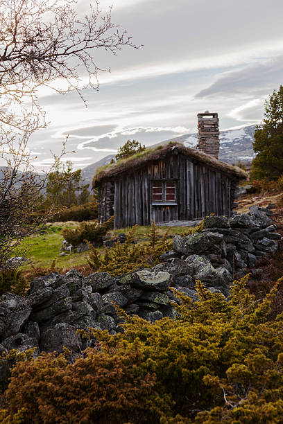 Abandoned  backlit summer farm in the Norwegian mountains at sunset. Sel, Gudbrandsdalen, Norway. 