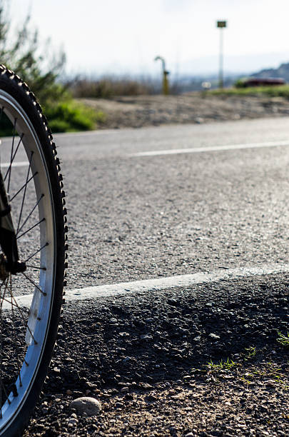 istock bike in a foothpath intersected by a road 477184719