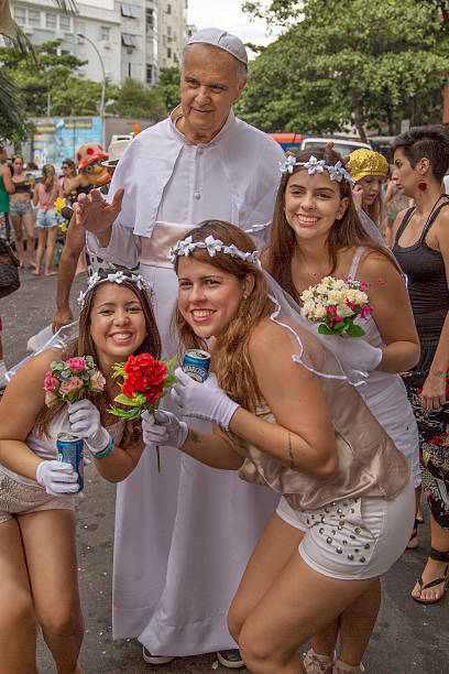 Street Carnival in Rio Rio de Janeiro, Brazil - March 1, 2014: Pope blesses three fiancee teenagers few minutes before Ipanema Band 50th Parade nudie suit stock pictures, royalty-free photos & images