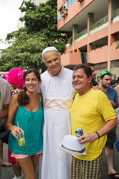 Street Carnival in Rio Rio de Janeiro, Brazil - March 1, 2014: Pope is photographed with a couple few minutes before Ipanema Band 50th Parade nudie suit stock pictures, royalty-free photos & images