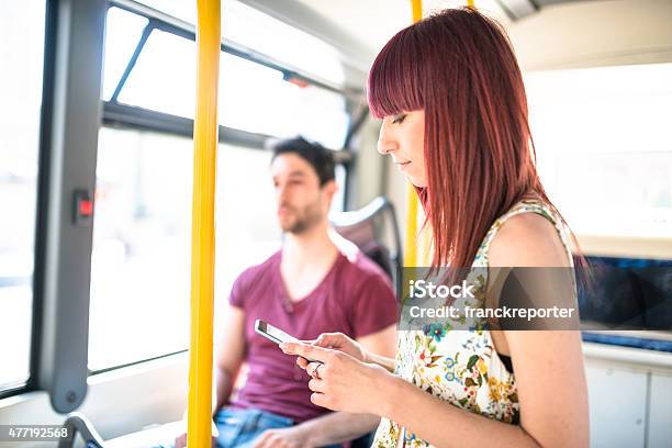 Friends Talking And Using The Smartphone Inside A Bus Stock Photo - Download Image Now