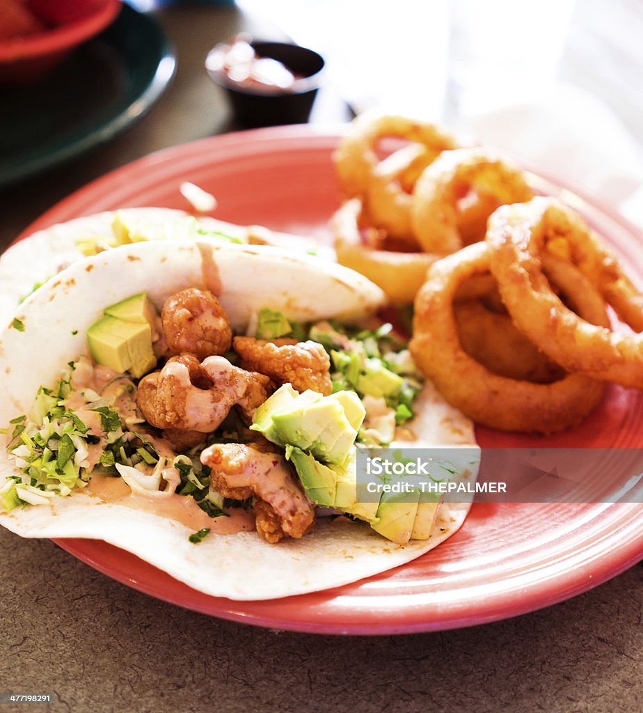 shrimp tacos shrimp tacos with avocado and fried onion rings as a side Avocado Stock Photo