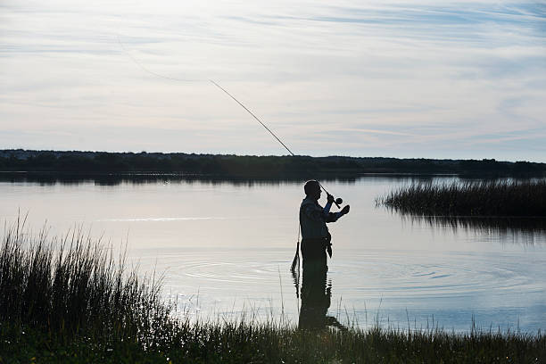 istock Senior man fly fishing 477198585