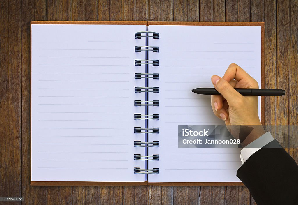 Hand writing in open paper on table Book Stock Photo
