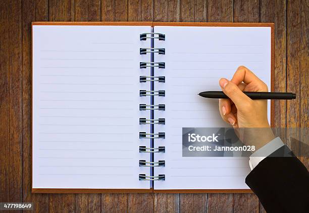 Hand Writing In Open Paper On Table Stock Photo - Download Image Now - Book, Business, Close-up