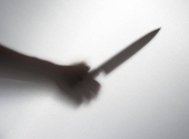 istock Silhouette of someone holding knife,blur image 477198854