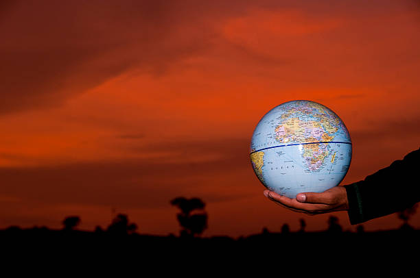 istock Young Man Holding a Earth Globe in his hands 477199616