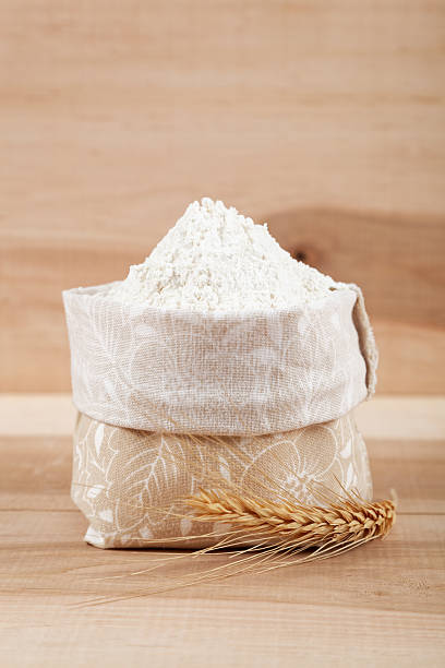 istock Flour in a canvas bag and ear of wheat. 477199962
