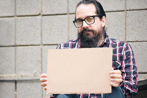 istock Hipster or Homeless Man Holding Blank Sign 477199972