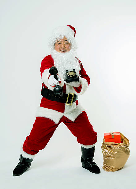 Santa claus speaking on the phone isolated on white background.