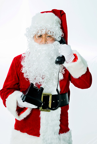 Santa claus speaking on the phone isolated on white background.