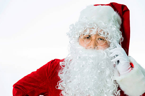 istock Santa claus talking by mobile phone 477203870