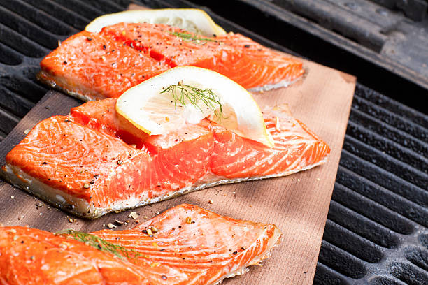istock Cedar Plank Salmon Filets on a Barbecue Grill 477203944