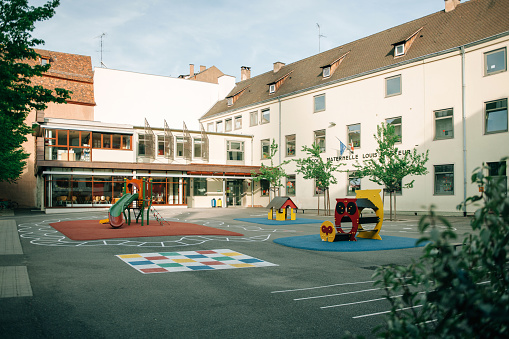 Paris, France - April 24, 2015: Louis Pasteur Ecole Maternelle the nursery school in Strasbourg, France on a calm evening with empty playgrounds and yard