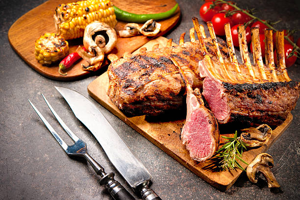 Grilled Rack of lamb Grilled Rack of lamb on a cutting board rack of lamb stock pictures, royalty-free photos & images