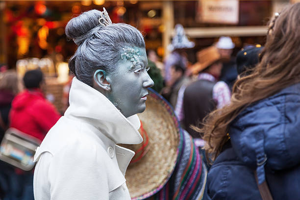 Cologne, Germany - March 03, 2014: unidentified creative painted woman walking in the crowd at Cologne Carnival