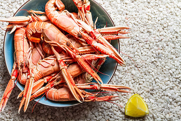 istock Scampi served with lemon on the beach 477209547