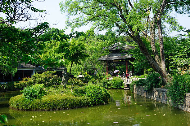 Scenic Yuantouzhu Park in Wuxi WuXi, China - April 26, 2015. Tourists in scenic Yuantouzhu Park in Wuxi, Jiangsu Province. Yuantouzhu is a beautiful peninsula park on the northern shore of Taihu (Lake Tai) and one of the most popular tourist destinations in Wuxi. lake tai stock pictures, royalty-free photos & images