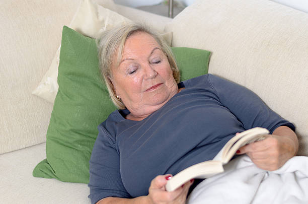 istock Close up Middle Aged Blond Woman Resting on Couch 477211368