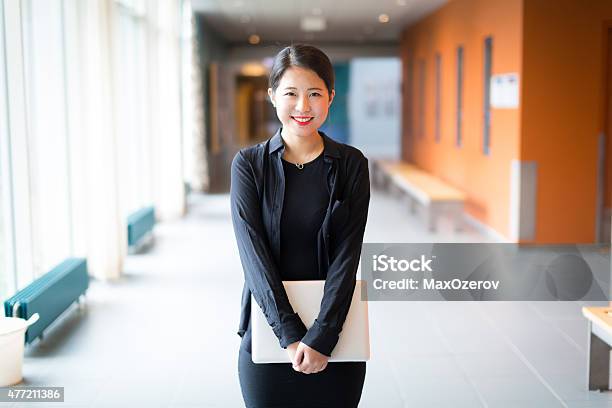Asian College Student Standing With A Laptop Stock Photo - Download Image Now - University Student, Chinese Ethnicity, Student