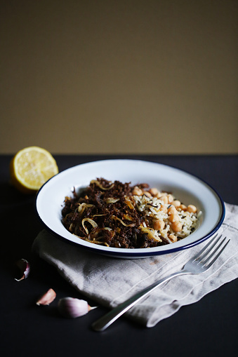 Fried beef meat pulled apart with wild rice and chickpeas, traditional cuban dish called vaca frita or ropa vieja