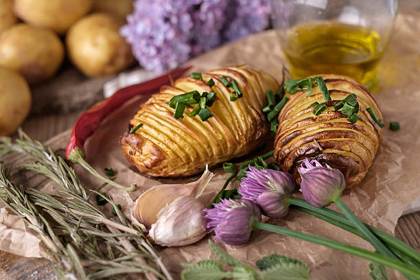 istock Sliced baked potatoes over wooden background. 477214160