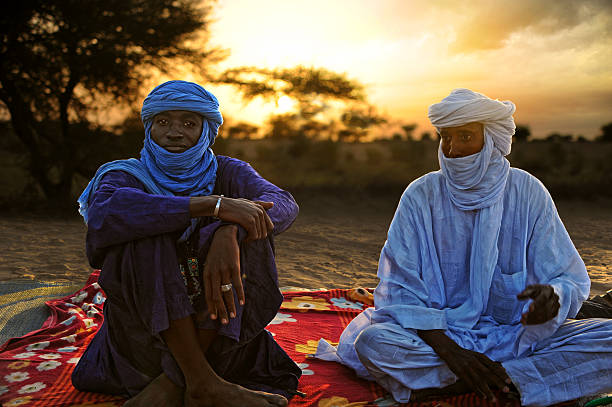 Tuaregs in Timbuktu Timbuktu, Mali - september - 02 - 2011 Tuaregs resting on his carpet and ready to drink tea after a hard day's trek through the desert to Timbuktu libyan culture stock pictures, royalty-free photos & images