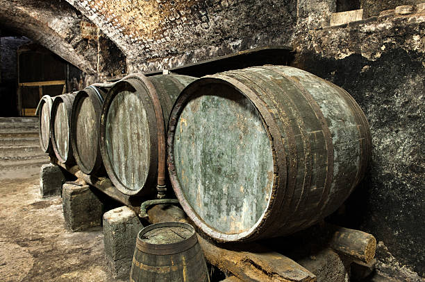 istock Old Keg Barrels in Row in Old Wine Cellar 477214690
