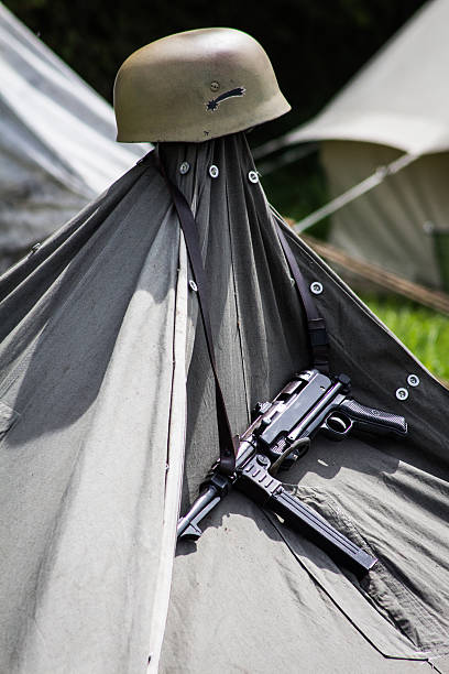istock Pistol and Helmet Hanging on a Tent 477215082