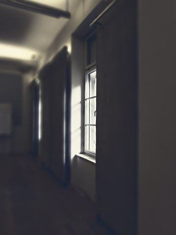 Dark room with illuminated window that morning light shining throuh it