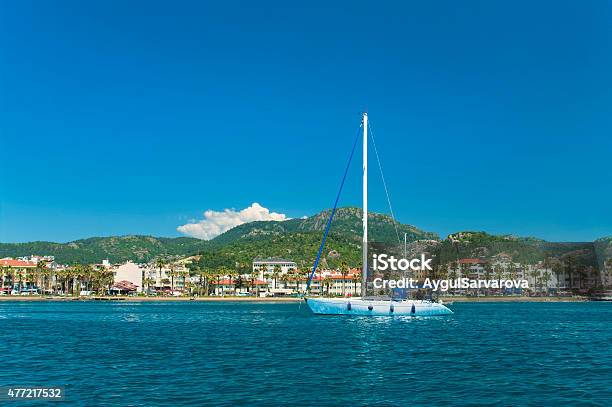 White Yacht Near Beach With Mountains At Back Stock Photo - Download Image Now - 2015, Asia, Bay of Water