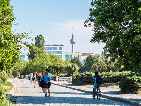 Berlin, Germany - June 11, 2015: People are walking at Mauerpark in Berlin. The TV-Tower is in the background.