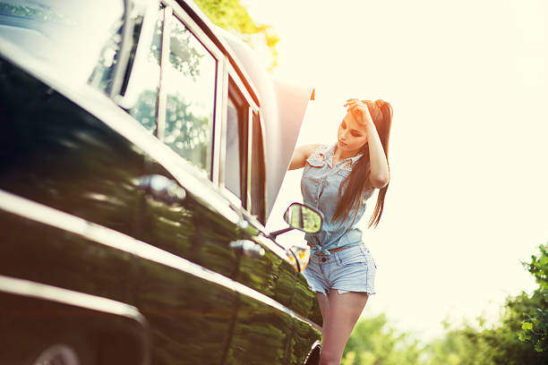 istock Attractive Retro Woman Fixing the Old Timer Car at Sunset 477223556