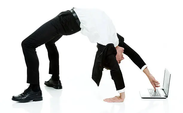 Photo of Businessman using laptop in yoga posture