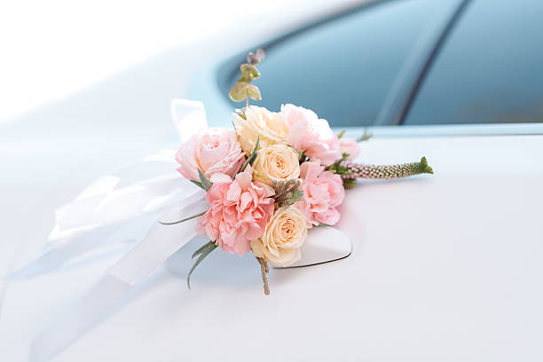 Wedding car with beautiful decorations of pink and orange roses
