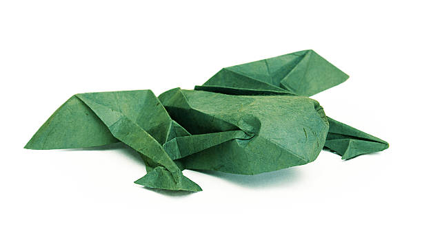 Origami green paper frog on a wtite background