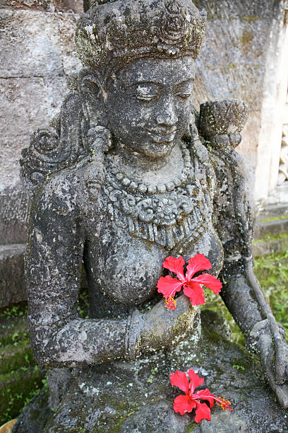 istock Hindou goddess statue holding pink hibiscus flowers 477237665