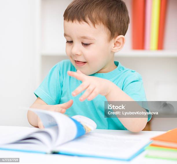 Little Boy Is Reading A Book Stock Photo - Download Image Now - Book, Brown Hair, Cheerful