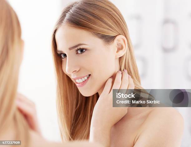 Young Woman Looking In The Mirror And Smiling Stock Photo - Download Image Now - 20-29 Years, Adult, Adults Only