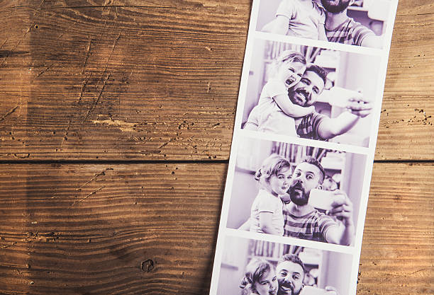 Fathers day composition Black and white pictures of father and daughter laid on wooden floor background. father photos stock pictures, royalty-free photos & images