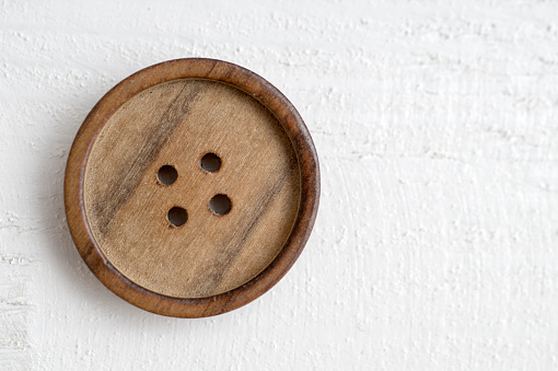 button on a wooden table, from above