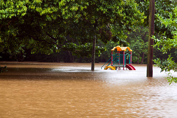 Childrens playground under water after heavy flooding Childrens playground under water after heavy rain and flooding in Queensland Australia queensland floods stock pictures, royalty-free photos & images
