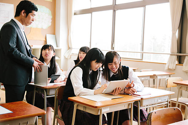 istock High school class and teacher with tablet computer, Japan 477252630