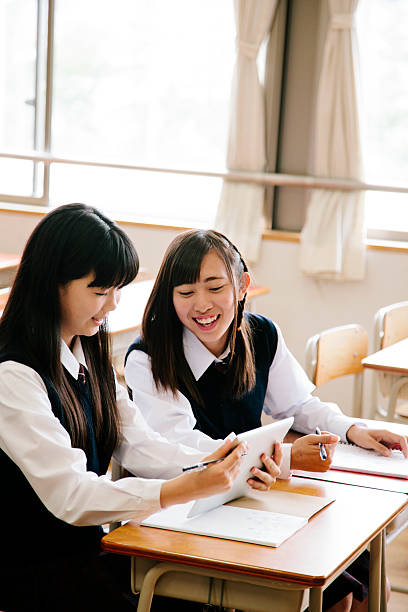 istock High school girls, using tablet computer, in a classroom, Japan 477252634