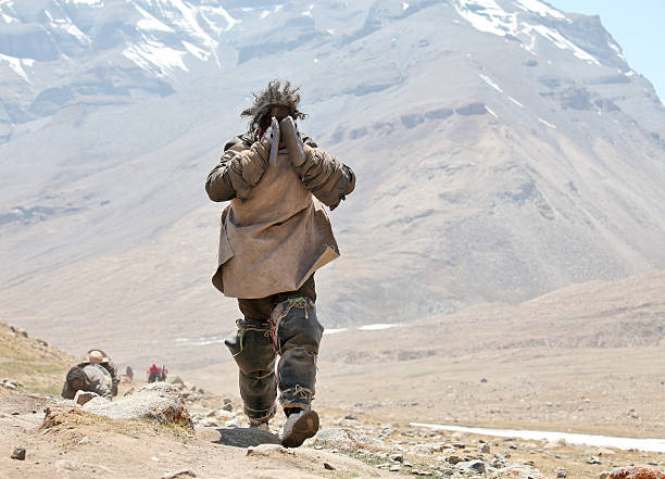 Mt Kailash, Tibet, China - May 26, 2012: Buddhist pilgrim walking the kora around Mt. Kailash and performing full body prostrations 