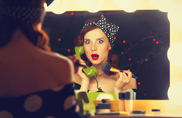 istock woman with dial phone applying cosmetics 477262906